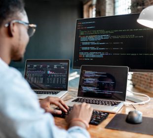 A man sitting at a table using a laptop