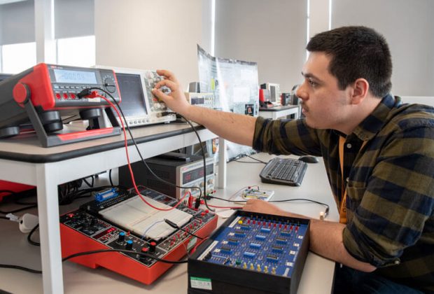A man standing in front of a computer