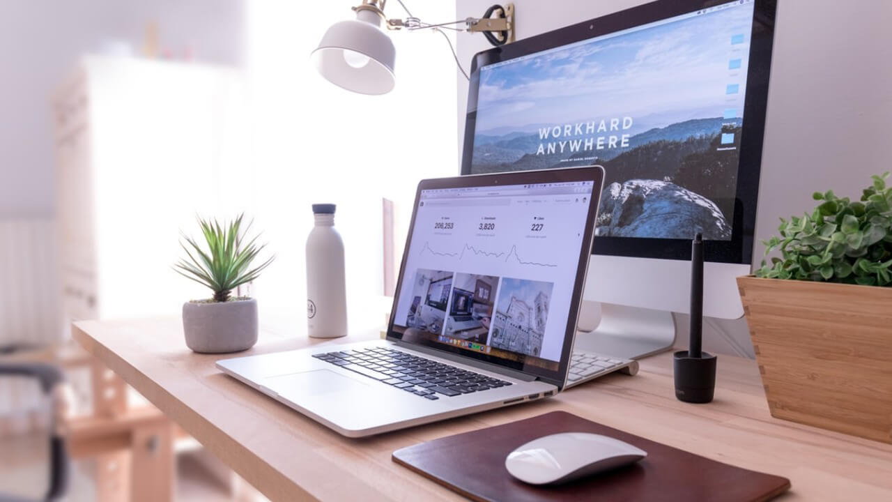 A laptop computer sitting on top of a wooden table