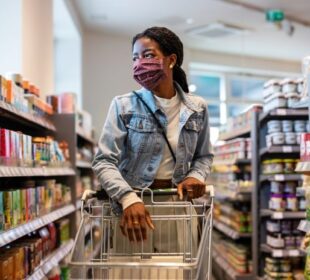 A girl wearing a mask and shopping